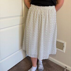 Grey midi skirt with a textured pattern all over the skirt